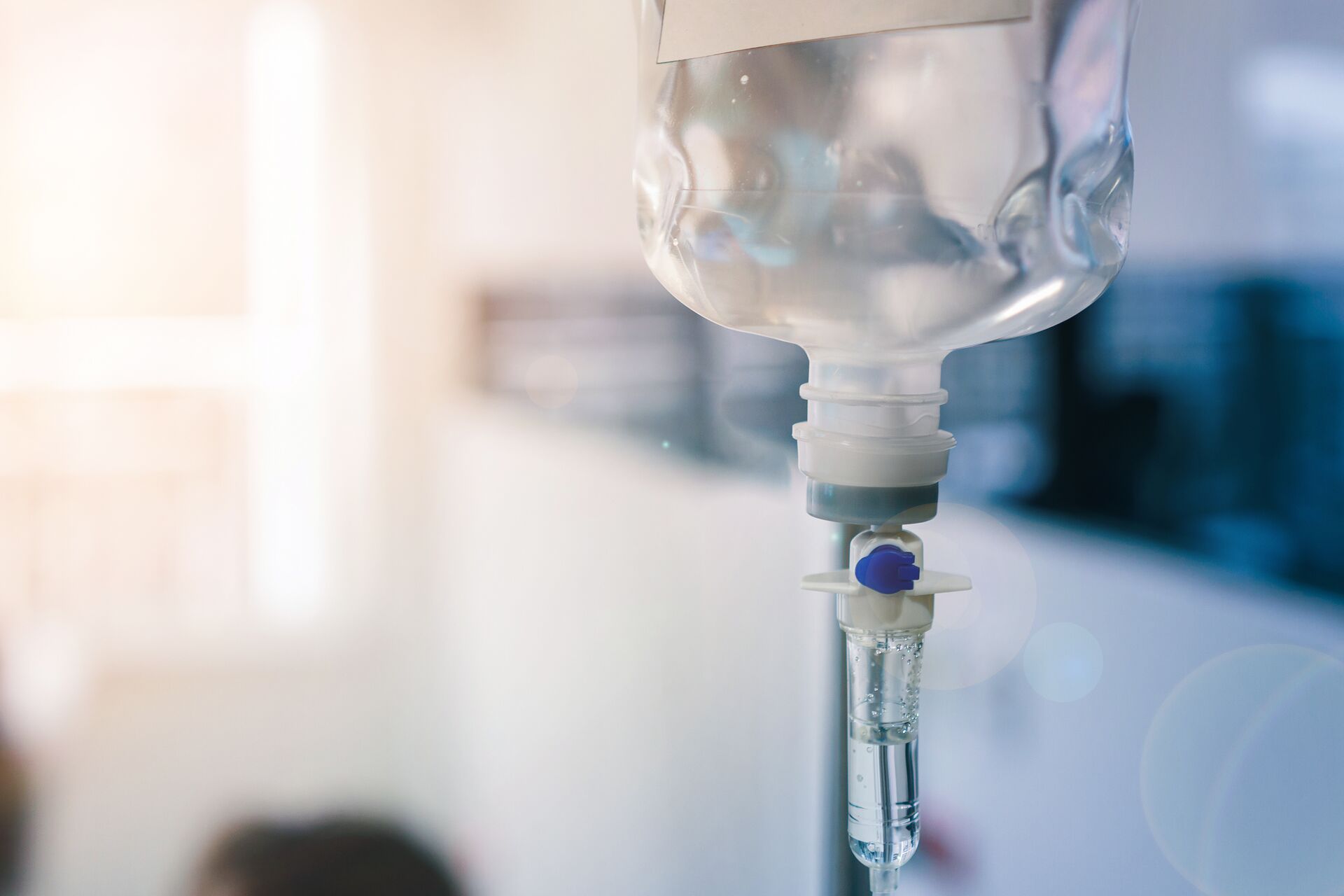 Healthcare concept, Close up of medical drip or IV drip chamber in patient room, Selective focus