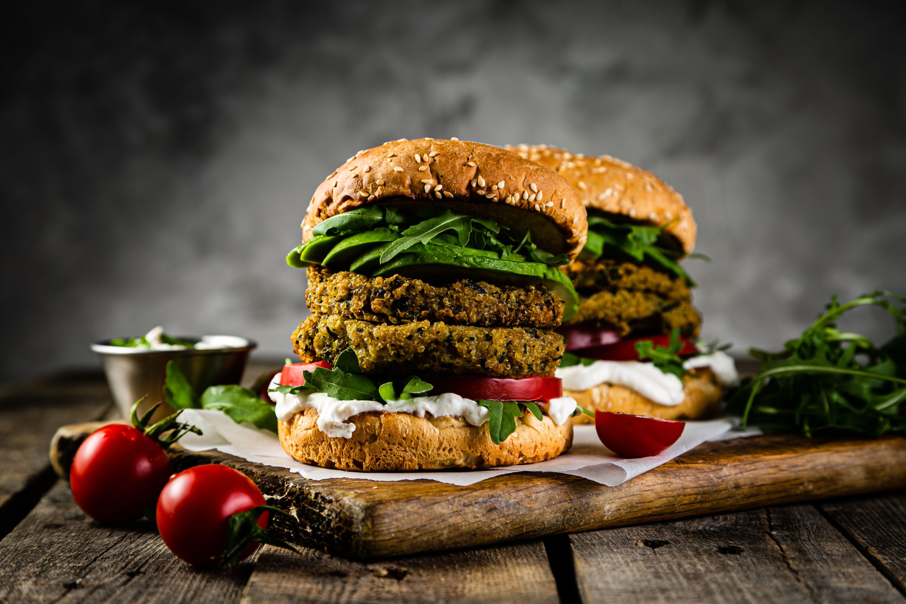 Vegan zucchini burger and ingredients on rustic wood background