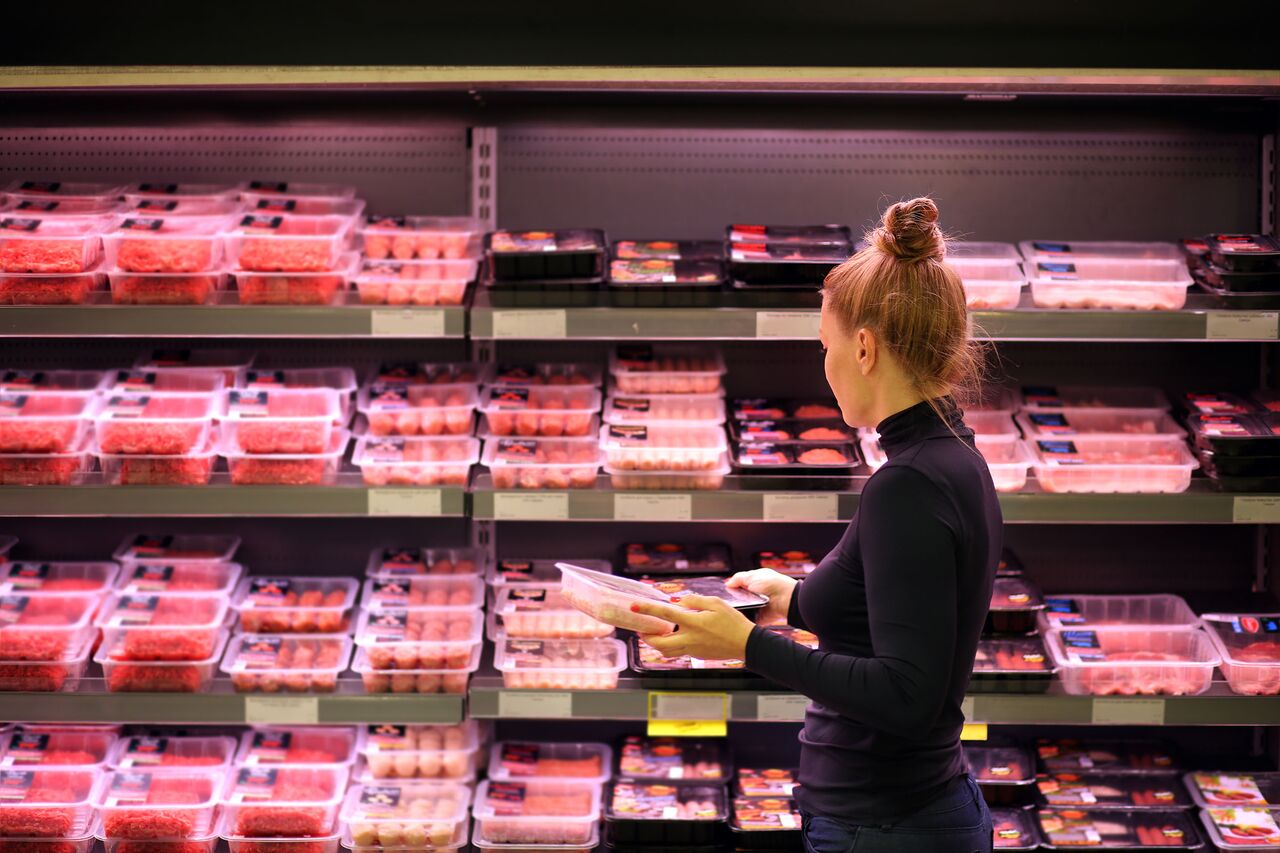 Customer Shopping in Meat Section of Grocery Store Lifestyle Photo