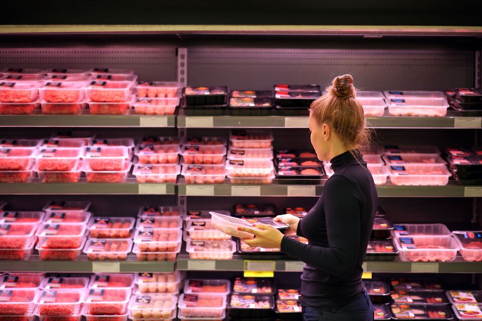 Customer Shopping in Meat Section of Grocery Store Lifestyle Photo
