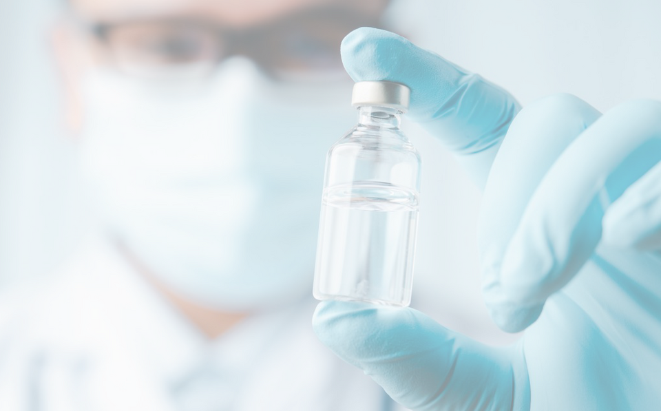 Lab worker inspecting vaccine
