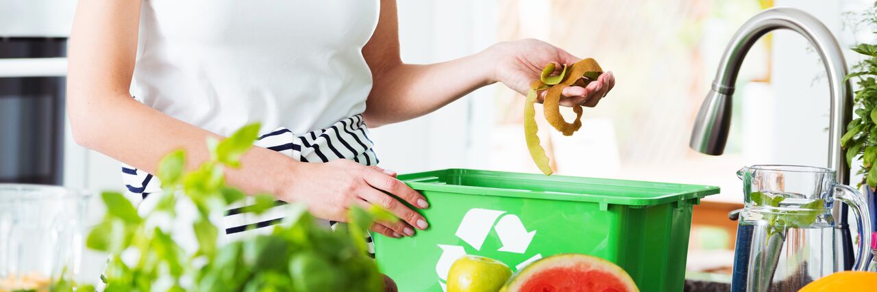 Woman composting biodegradable waste