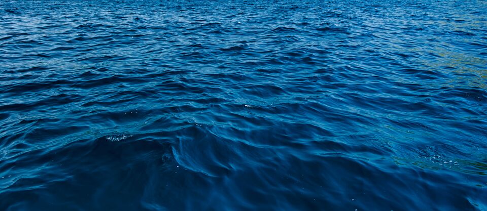 close up blue water surface at deep ocean