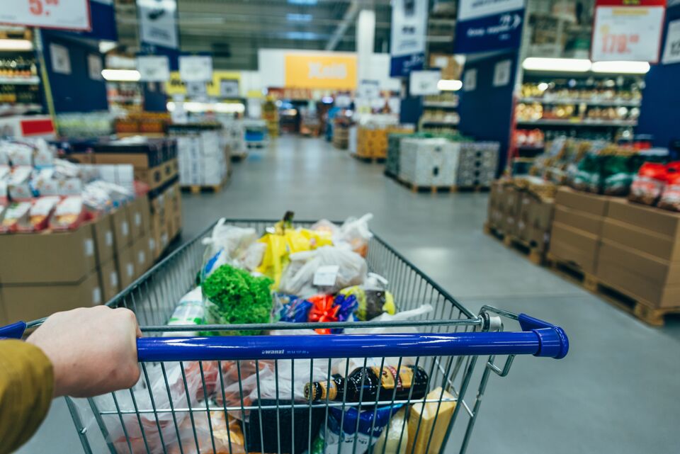 first person view. man with trolley in grocery store. shopping concept