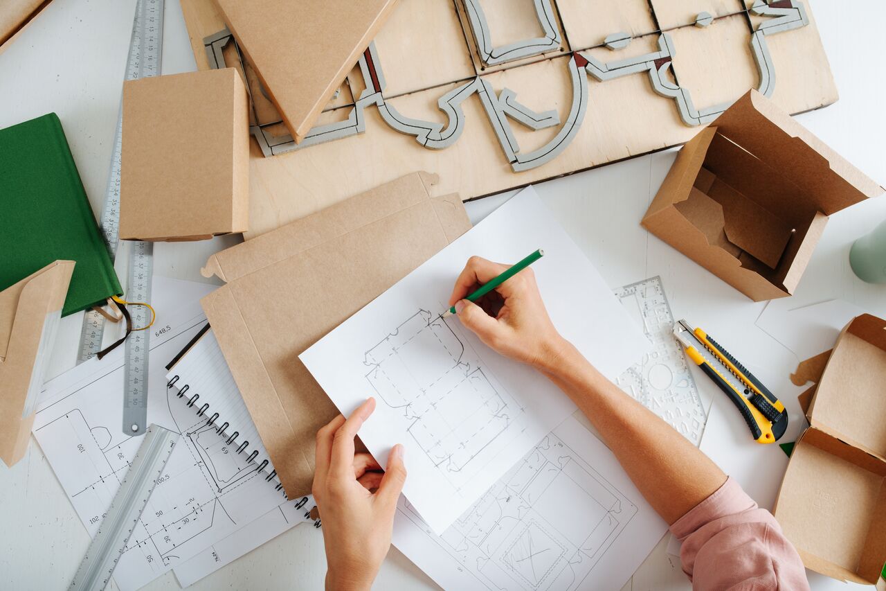 Designer in the works, she makes a drawing of a new box