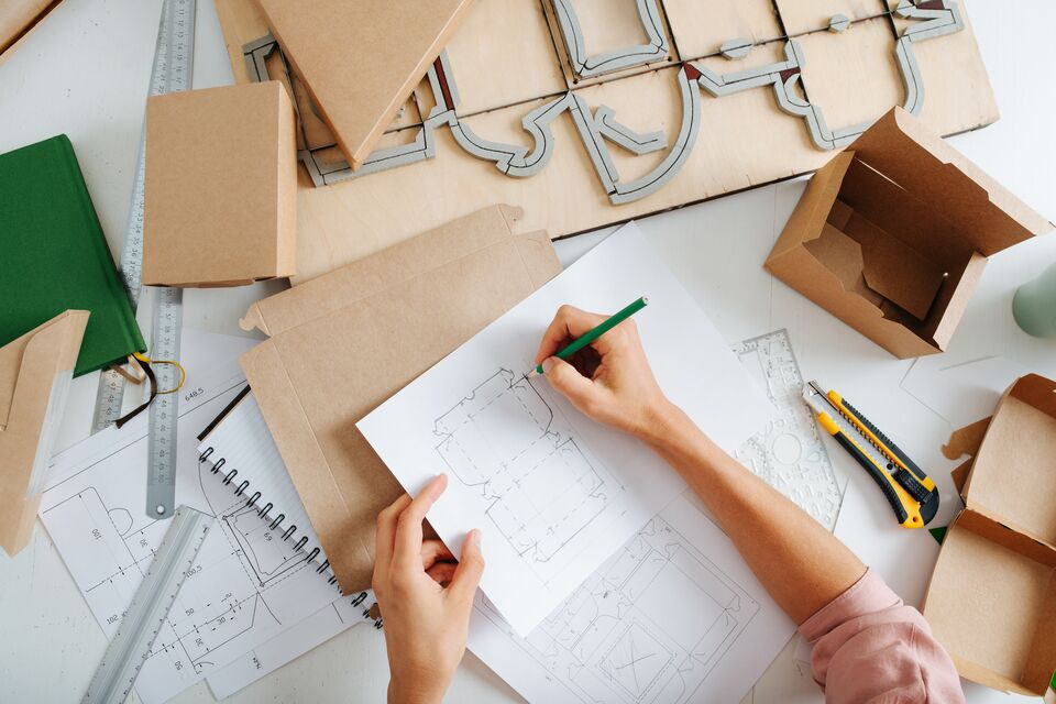 Designer in the works, she makes a drawing of a new box