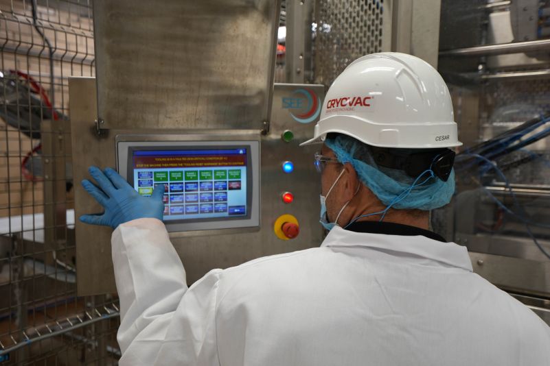 Image-of-meat-packing-worker-using-a-touch-screen